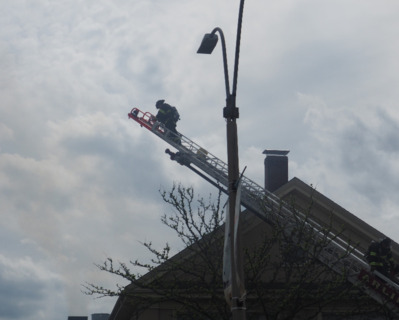 Arlington Ma. Firefighter attacking a fire through the roof